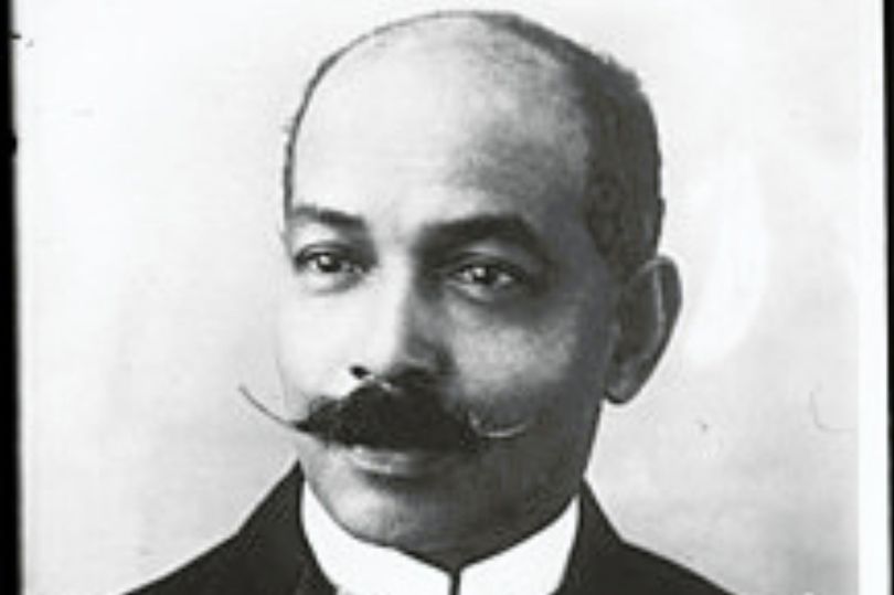 Black and white picture of a black man with a moustache